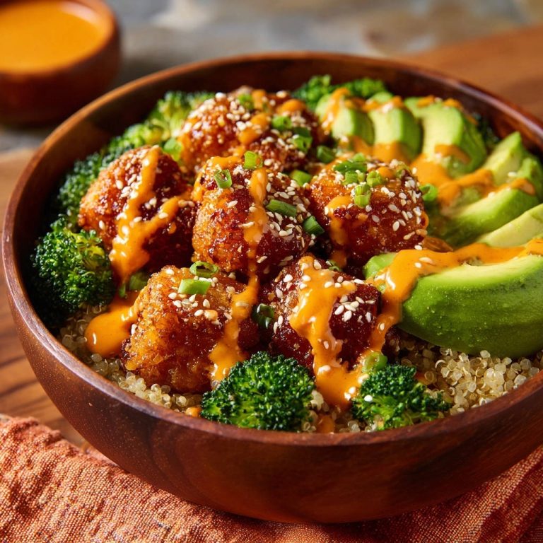 Knusprige Asian Chicken Bowl mit Chili-Limetten-Dressing, garniert mit Sesam und Frühlingszwiebeln, in einer Holzschale serviert.